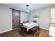 Charming dining room with modern light fixture, table with bench and chairs, and a sliding barn door at 5440 Wheeler Ridge Rd, Auburn, GA 30011