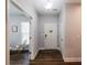 Bright foyer with dark floors, white door, and neutral wall color at 5440 Wheeler Ridge Rd, Auburn, GA 30011
