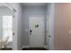 Bright foyer with dark floors, white door, and neutral wall color at 5440 Wheeler Ridge Rd, Auburn, GA 30011