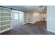 Spacious hallway featuring sliding barn doors, gray carpet, and neutral paint, leading to additional rooms at 5440 Wheeler Ridge Rd, Auburn, GA 30011