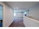 Upstairs hallway with plush carpet and slider door, offering a bright and functional living space at 5440 Wheeler Ridge Rd, Auburn, GA 30011