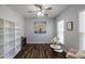 Bright home office featuring a ceiling fan, built-in shelving, and two windows at 5440 Wheeler Ridge Rd, Auburn, GA 30011