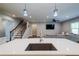 Open concept living space featuring a kitchen island with quartz countertops and a stainless steel sink at 5440 Wheeler Ridge Rd, Auburn, GA 30011