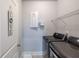Functional laundry room with modern washer and dryer, wire shelving, and neutral gray walls at 5440 Wheeler Ridge Rd, Auburn, GA 30011