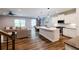 Open floor plan living area featuring hardwood floors, a spacious kitchen, and modern decor and lighting at 5440 Wheeler Ridge Rd, Auburn, GA 30011
