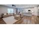 Open-concept layout seamlessly combines living room, dining area, and kitchen with modern finishes and appliances at 5440 Wheeler Ridge Rd, Auburn, GA 30011