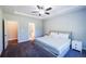 Spacious main bedroom with a tray ceiling, ceiling fan, bedside tables, and ensuite access at 5440 Wheeler Ridge Rd, Auburn, GA 30011