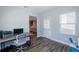 Functional office featuring a modern desk, view to backyard, access to stairs, and comfortable chair at 5440 Wheeler Ridge Rd, Auburn, GA 30011
