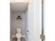 Bright powder room with gray walls, tiled flooring, and decorative shelf, offering a convenient space at 5440 Wheeler Ridge Rd, Auburn, GA 30011