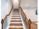 Elegant staircase featuring hardwood steps, painted risers, with stylish railings, leading to upper floors at 5440 Wheeler Ridge Rd, Auburn, GA 30011