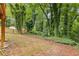 Fenced backyard featuring mature trees and providing ample space for outdoor activities at 1111 Pin Oak Dr, Tucker, GA 30084