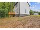 Side view of backyard featuring wood deck, lush trees, and landscaped area at 1111 Pin Oak Dr, Tucker, GA 30084
