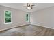 Bright bedroom with light gray walls, hardwood floors, and a ceiling fan at 1111 Pin Oak Dr, Tucker, GA 30084
