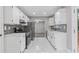 Bright kitchen featuring white cabinets, stainless appliances, and a mosaic tile backsplash at 1111 Pin Oak Dr, Tucker, GA 30084