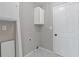 Laundry room featuring white cabinets and tile flooring at 1111 Pin Oak Dr, Tucker, GA 30084