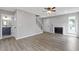 Bright living room boasts wood floors, a fireplace, and views of the front yard at 1111 Pin Oak Dr, Tucker, GA 30084