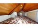 Expansive attic with patterned flooring and a wood paneled ceiling at 2344 Country Club Se Dr, Conyers, GA 30013