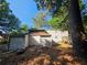 Backyard featuring a shed for storing tools and equipment, as well as ample shade at 2344 Country Club Se Dr, Conyers, GA 30013