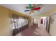 Bedroom with bright yellow walls and colorful ceiling fan, and neutral-colored carpeting at 2344 Country Club Se Dr, Conyers, GA 30013