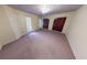 Bedroom with plush carpeting, multiple windows and closet with bi-fold doors at 2344 Country Club Se Dr, Conyers, GA 30013