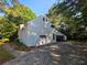 Side exterior view of the home with a long driveway leading to a covered carport at 2344 Country Club Se Dr, Conyers, GA 30013