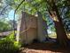 Exterior view of the home with a chimney surrounded by lush greenery and mature trees at 2344 Country Club Se Dr, Conyers, GA 30013