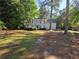 Charming two-story home with a well-maintained lawn and mature trees at 2344 Country Club Se Dr, Conyers, GA 30013
