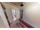 Bright hallway with access to rooms, staircase with wooden banister and carpeted steps at 2344 Country Club Se Dr, Conyers, GA 30013