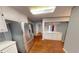 Kitchen with stainless steel appliances, white cabinets, and wood-look floors at 2344 Country Club Se Dr, Conyers, GA 30013