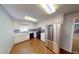 Kitchen with stainless steel appliances, white cabinets, and wood-look floors at 2344 Country Club Se Dr, Conyers, GA 30013