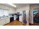 Well-lit kitchen with white cabinets, stainless steel refrigerator, and modern appliances at 2344 Country Club Se Dr, Conyers, GA 30013