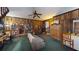 Spacious living room with wood-paneled walls, ceiling fan and comfortable seating at 2344 Country Club Se Dr, Conyers, GA 30013