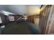 Living room view showing the wood paneled walls, ceiling fan, and staircase at 2344 Country Club Se Dr, Conyers, GA 30013