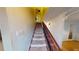 Carpeted staircase with wooden railing, leading to the upper level of the home at 2344 Country Club Se Dr, Conyers, GA 30013