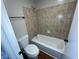 Bathroom features tile surround, and toilet in a tiled bath/shower area at 2449 Terrace Trl, Decatur, GA 30035