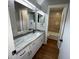 Bathroom features vanity with granite top, wood floor and tile in bath/shower area at 2449 Terrace Trl, Decatur, GA 30035
