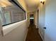 Hallway with hardwood floors and a window looking out to the exterior of the house at 2449 Terrace Trl, Decatur, GA 30035