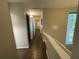 Hallway featuring hardwood floors, neutral paint, and a window overlooking trees at 2449 Terrace Trl, Decatur, GA 30035