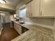 Modern kitchen with white cabinets, marbled countertops, and stainless steel appliances at 2449 Terrace Trl, Decatur, GA 30035