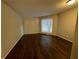Bright living room with dark hardwood floors and a large window providing natural light and views at 2449 Terrace Trl, Decatur, GA 30035