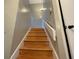 Ascending wood stairway with handrail, featuring neutral wall paint and contemporary lighting at 2449 Terrace Trl, Decatur, GA 30035