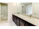Bathroom featuring a double vanity with granite countertops, dark cabinets, and a walk-in shower at 3065 Reserve Ct Sw, Conyers, GA 30094