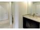 Bathroom featuring a double vanity with granite countertops, dark cabinets, and tile floors at 3065 Reserve Ct Sw, Conyers, GA 30094
