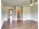 Bedroom with hardwood floors, a ceiling fan, and white doors leading to other rooms at 3065 Reserve Ct Sw, Conyers, GA 30094