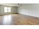 Large bedroom featuring hardwood floors, neutral walls, and a window providing natural light at 3065 Reserve Ct Sw, Conyers, GA 30094