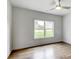 Bright bedroom with hardwood floors and large windows offering a backyard view at 3065 Reserve Ct Sw, Conyers, GA 30094