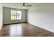 Bright bedroom with hardwood floors, neutral walls, and a large window offering scenic views at 3065 Reserve Ct Sw, Conyers, GA 30094