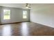 Bedroom featuring hardwood floors, neutral walls, and a ceiling fan at 3065 Reserve Ct Sw, Conyers, GA 30094