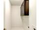 Functional laundry room features overhead cabinets and tiled flooring at 3065 Reserve Ct Sw, Conyers, GA 30094