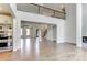 Bright living room with tall ceilings, hardwood floors, and adjacent stainless kitchen at 3065 Reserve Ct Sw, Conyers, GA 30094